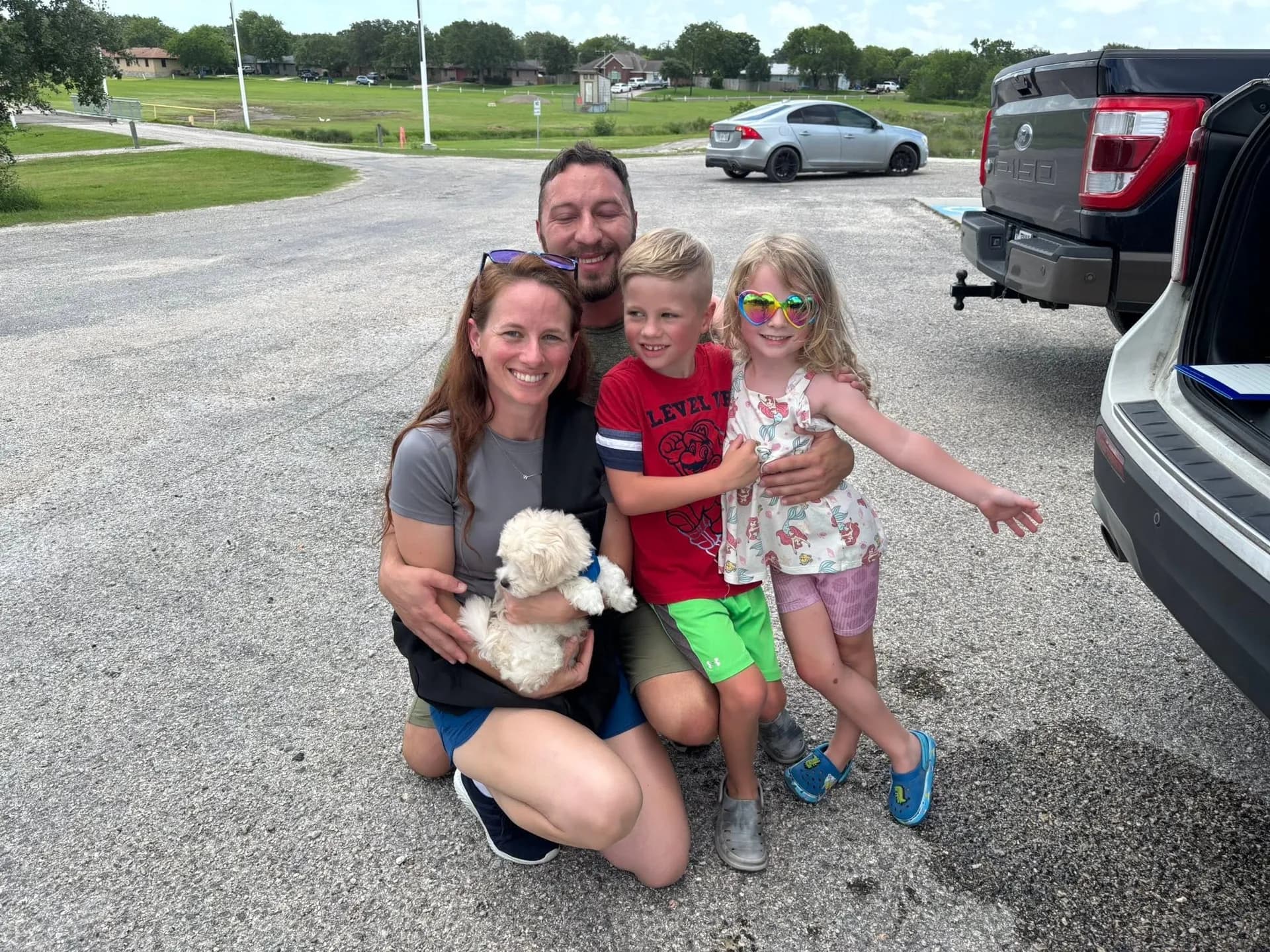A family with their new Hope Cotons puppy