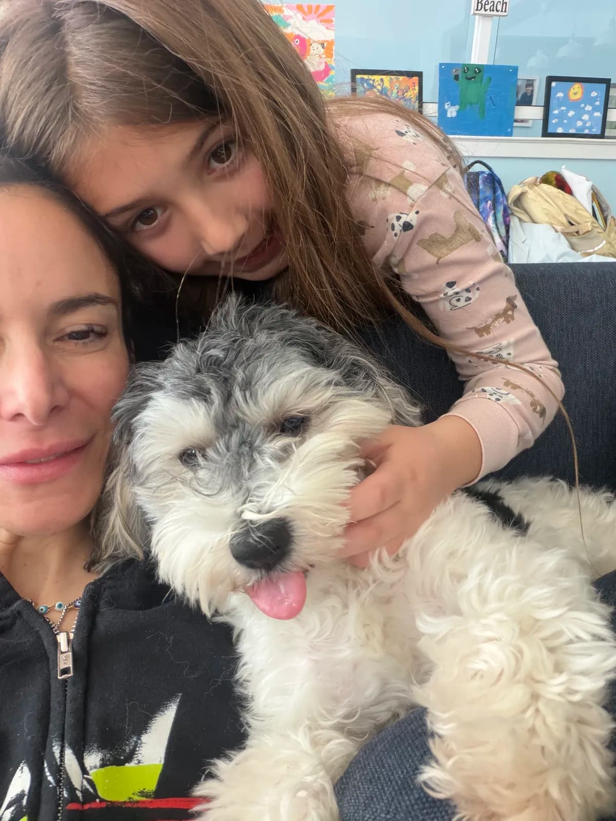 A mom and daughter snuggled up with their Coton