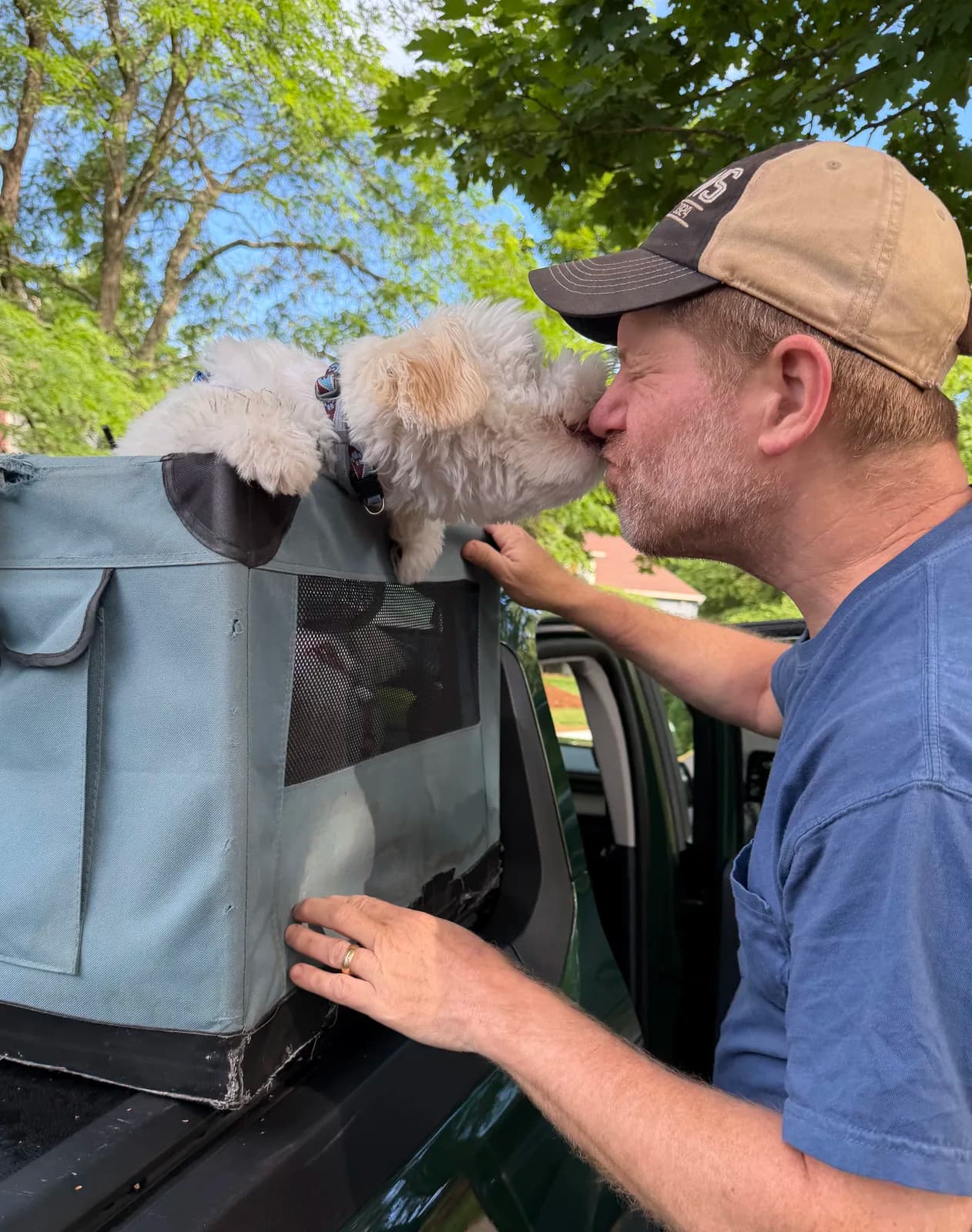 A goodbye kiss as a puppy heads home with his new family